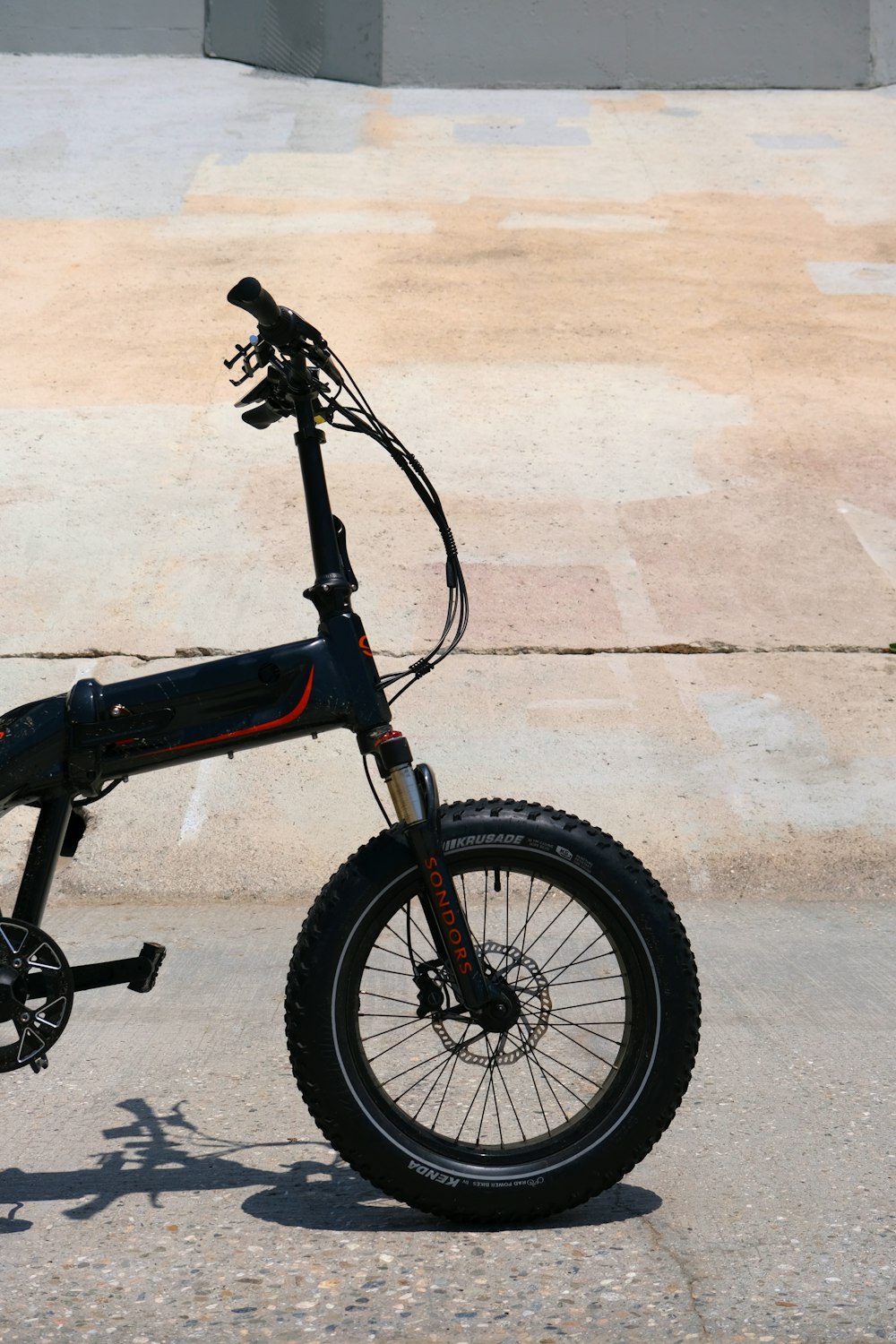 black bmx bike on gray concrete floor