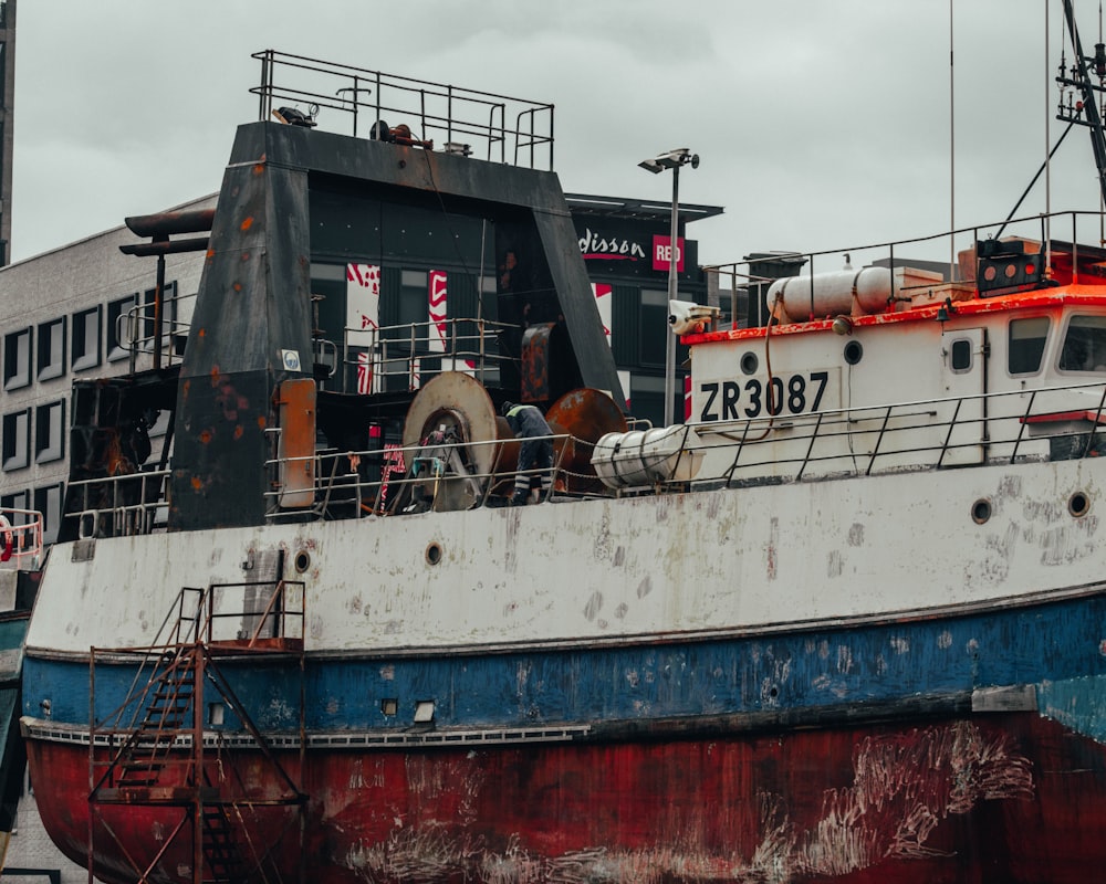 white and red ship on sea during daytime