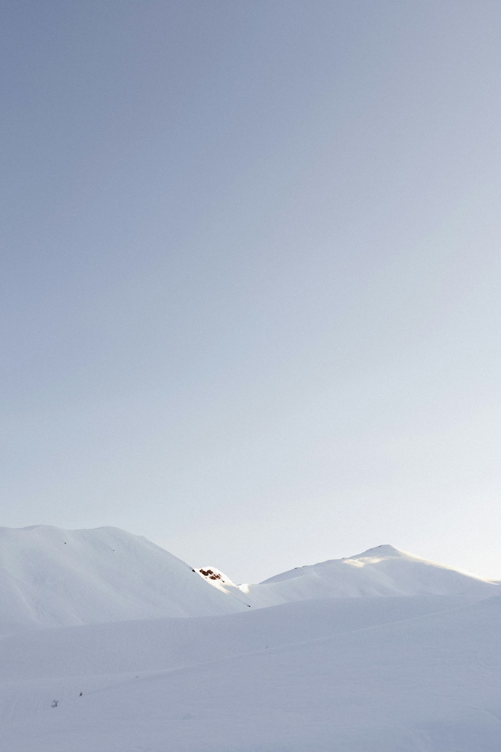 snow covered mountain under blue sky during daytime