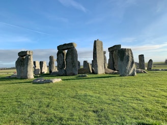 A team of researchers and cultural experts standing near the three stones of Cuesta in Botucatu under a clear sky.