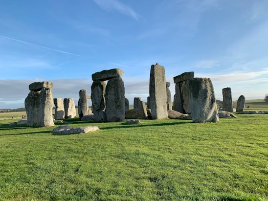 A team of researchers and cultural experts standing near the three stones of Cuesta in Botucatu under a clear sky.