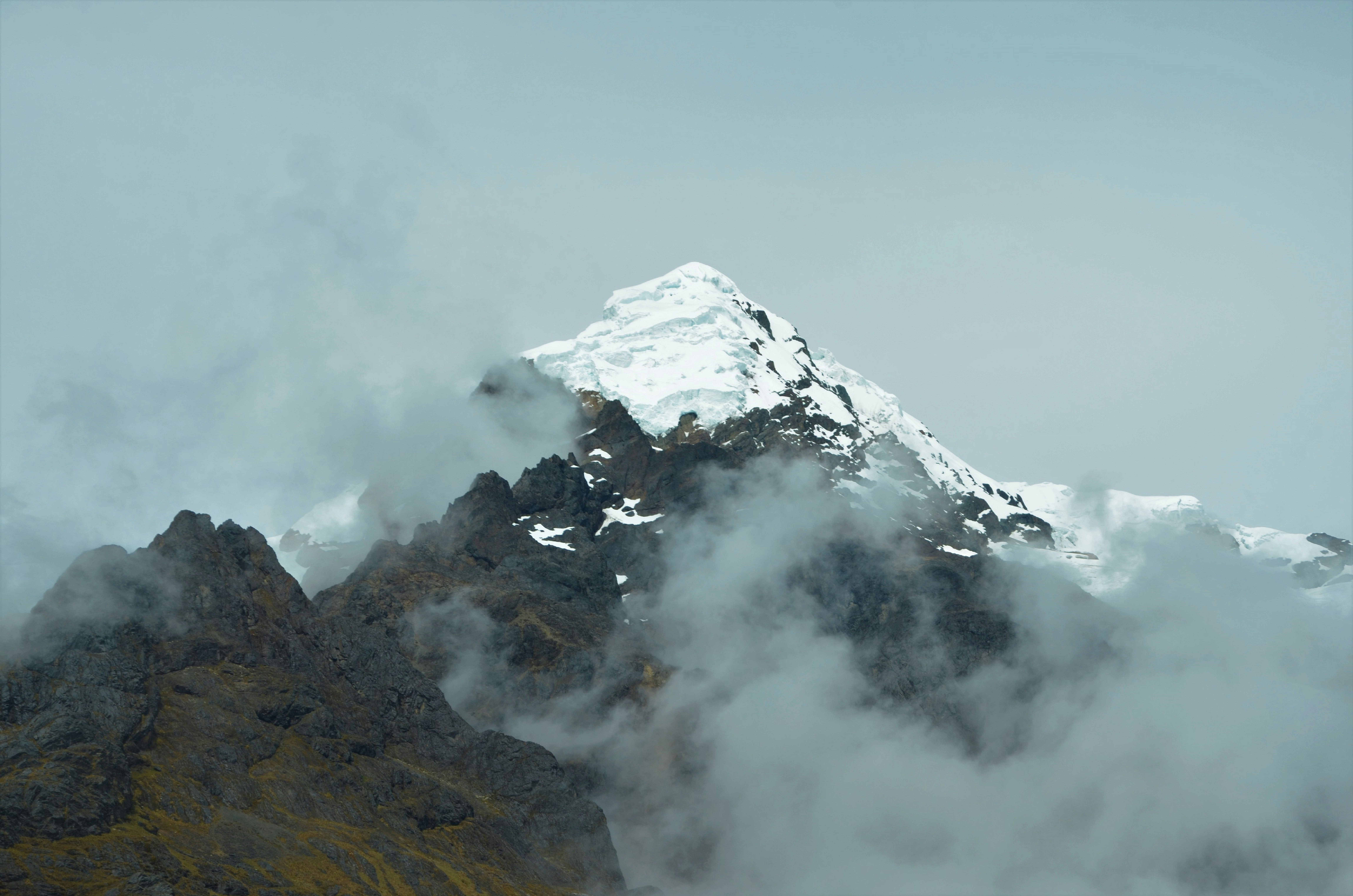 Dramatic misty mountain landscape at dawn, Dolomites peaks emerging from clouds