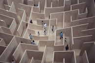A maze with a person standing confused at the center, representing mental manipulation.