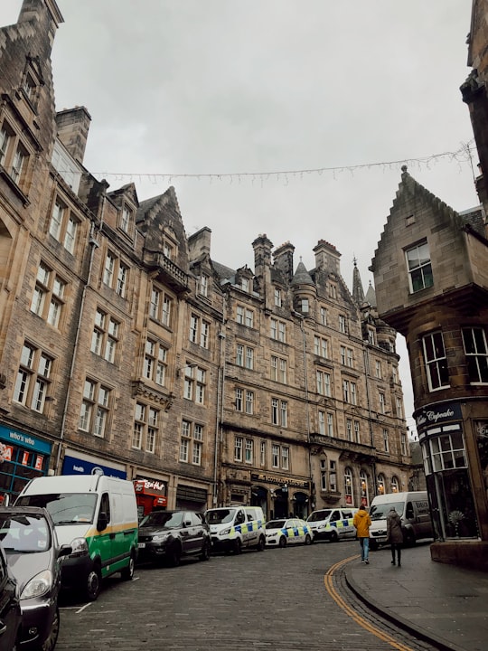 cars parked in front of brown concrete building during daytime in Cockburn Street, Edinburgh United Kingdom
