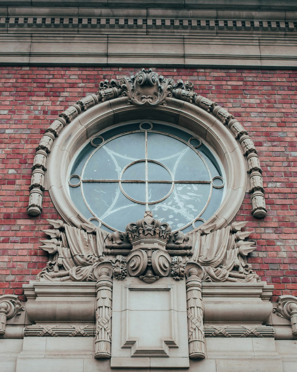 a circular window on the side of a brick building