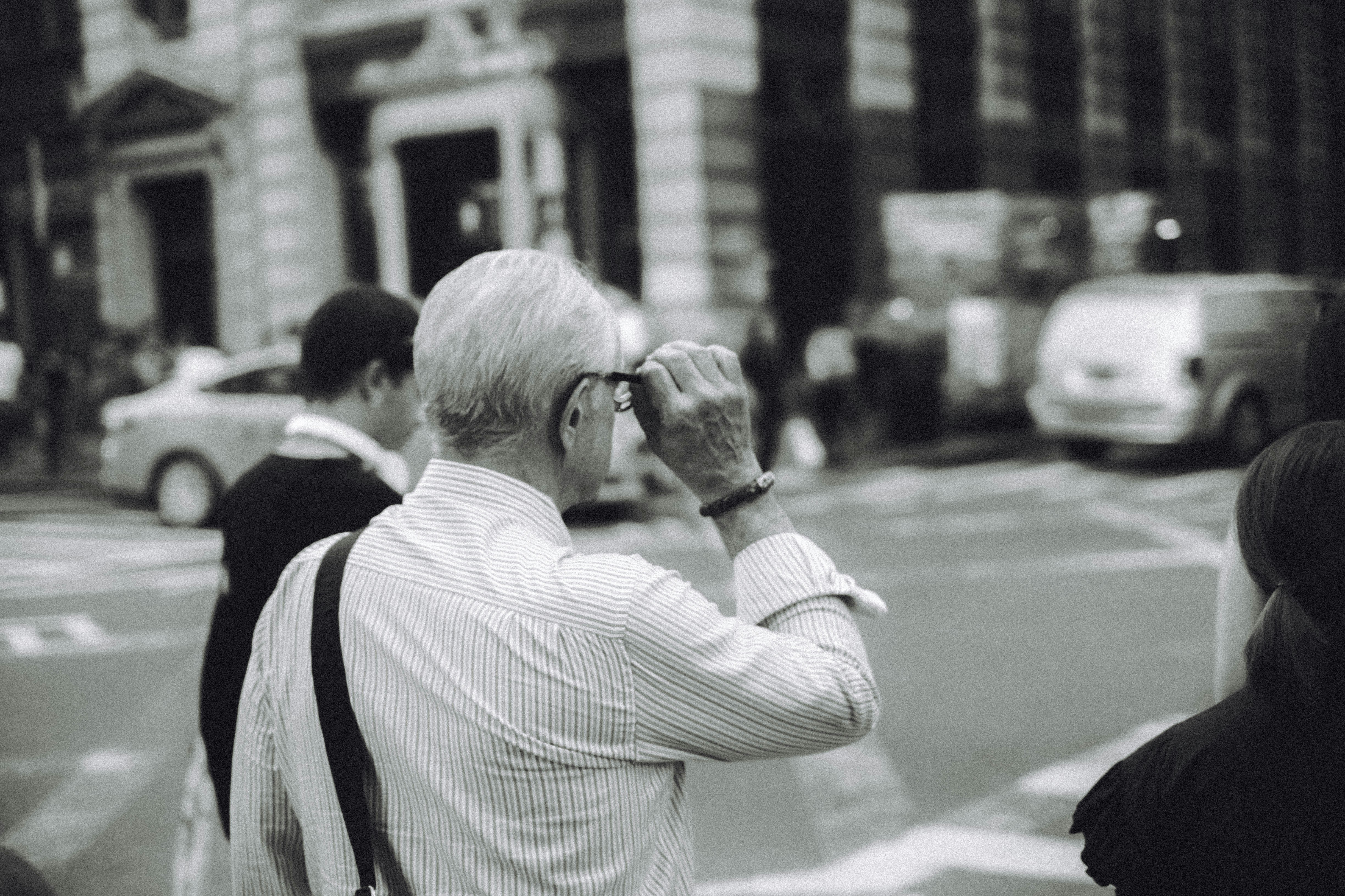 man in white dress shirt using camera