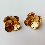 Elegant gold earrings shaped like traditional motifs.