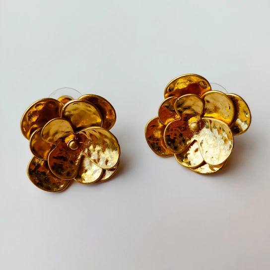 Elegant pair of traditional Indian gold-plated earrings displayed against a neutral background.