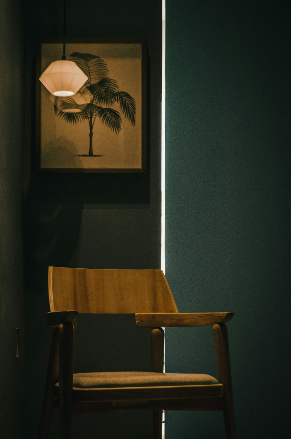 brown wooden chair near white wall