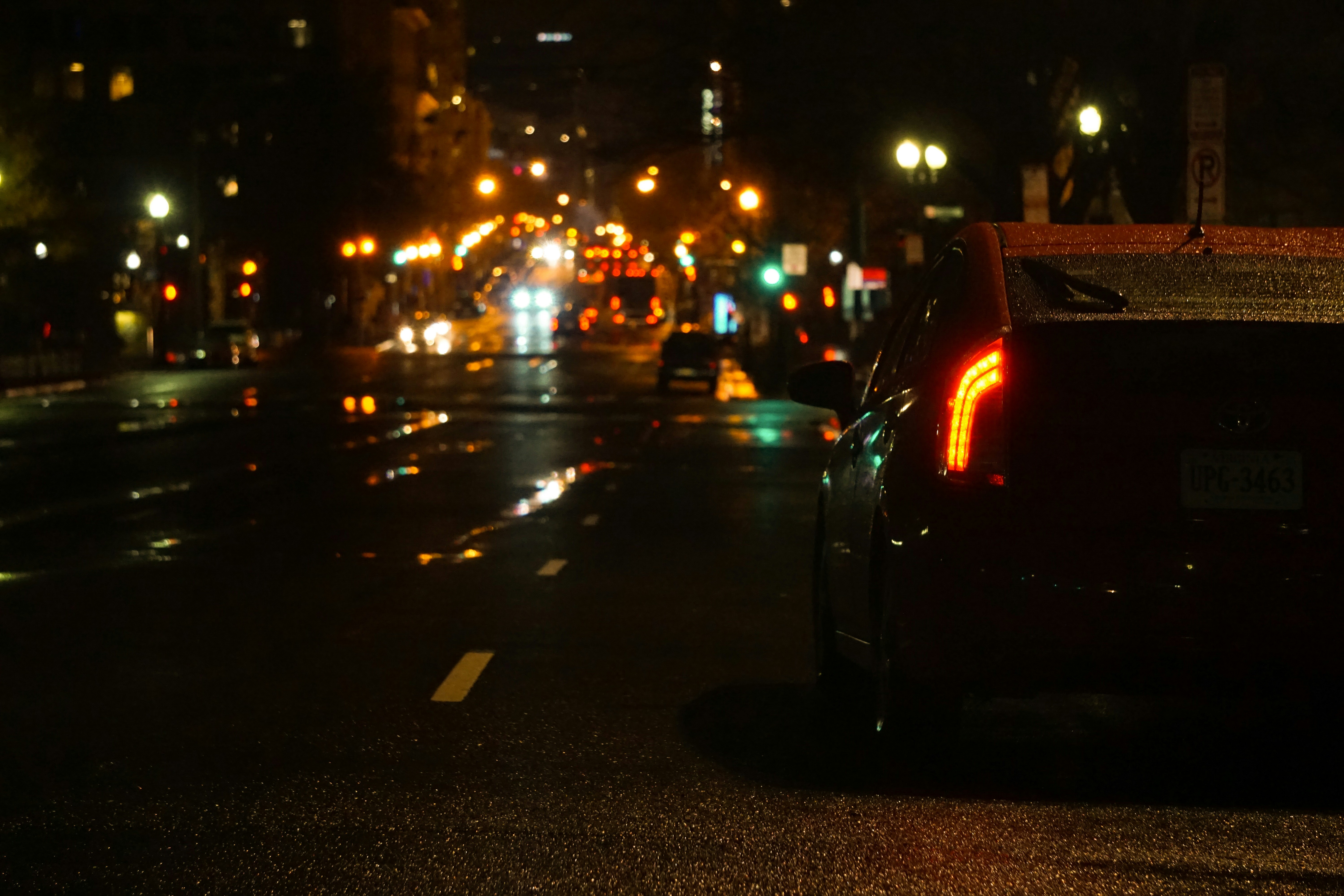 black car on road during night time