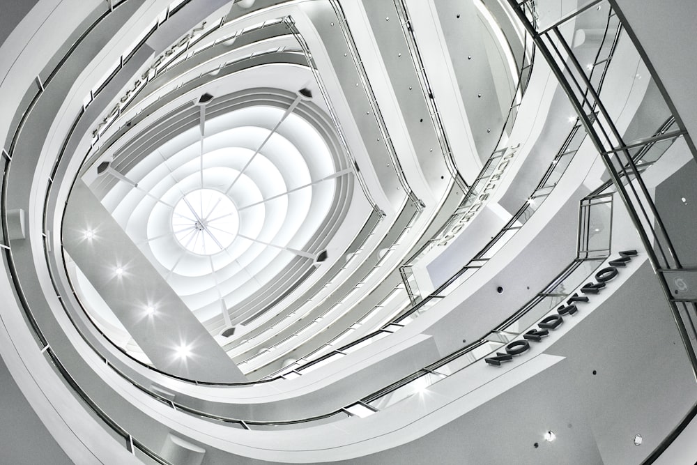 white spiral staircase in grayscale photography