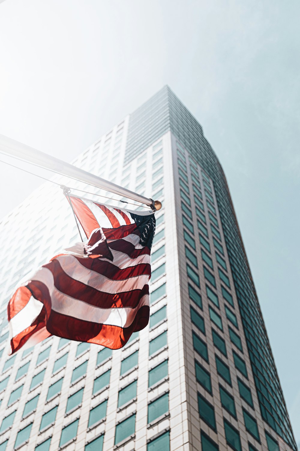 us a flag on pole near high rise building