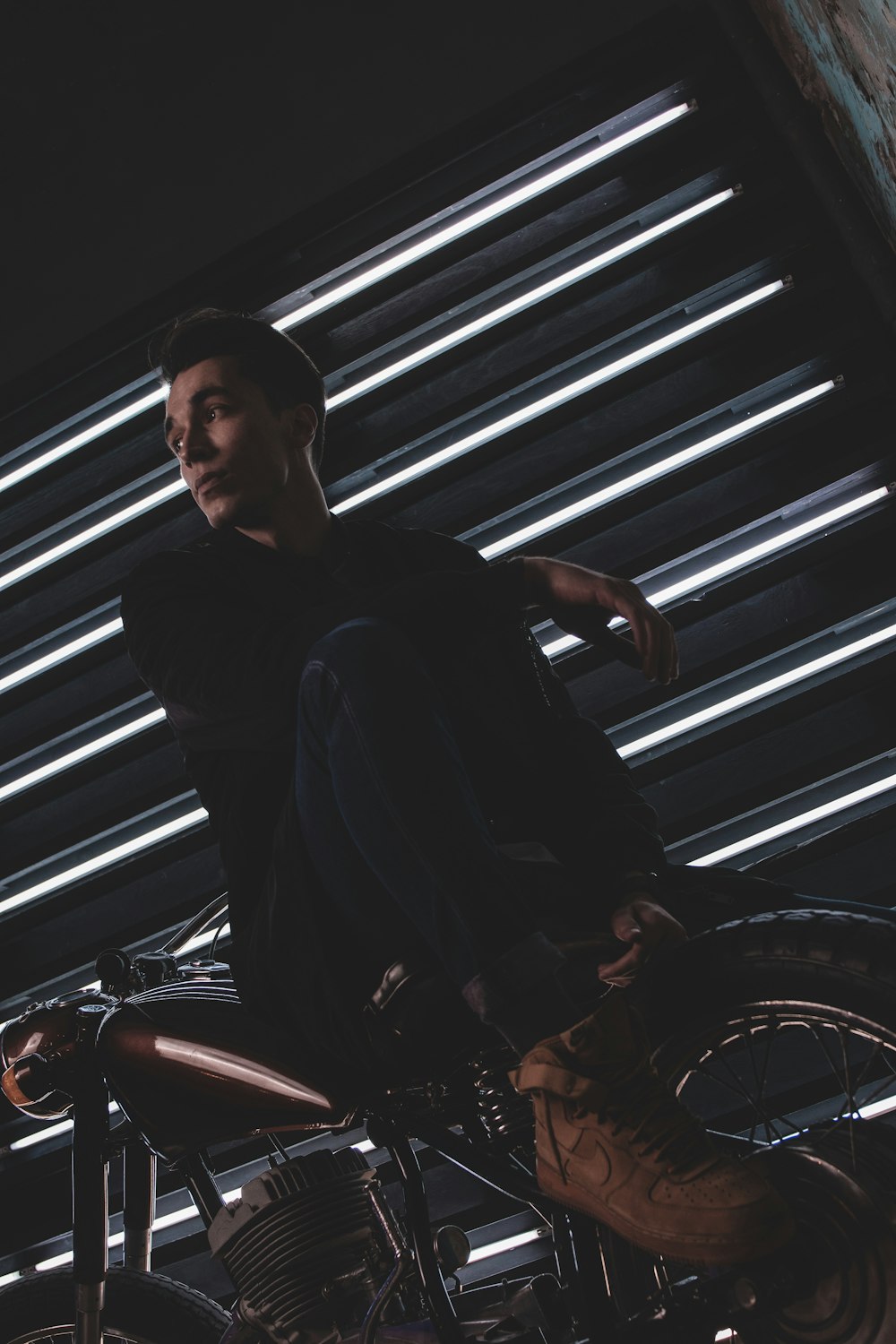 man in black long sleeve shirt sitting on red motorcycle