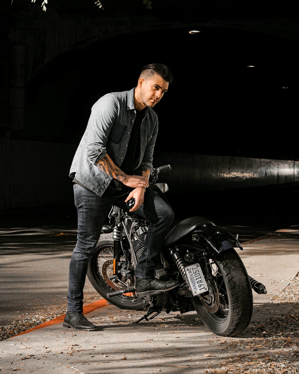 man in gray dress shirt riding black motorcycle