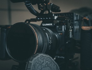 black nikon dslr camera on black table