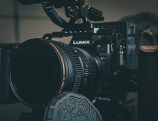black nikon dslr camera on black table