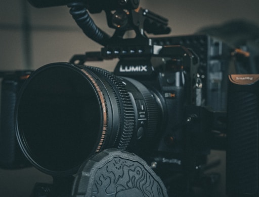 black nikon dslr camera on black table