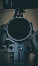 A close-up of a camera setup with various lenses and lighting equipment ready for use.
