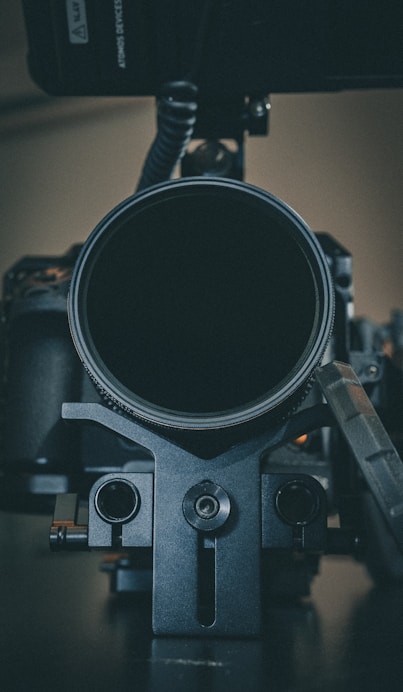 Close-up of a durable camera cable and L-shaped bracket in use on a professional camera setup.