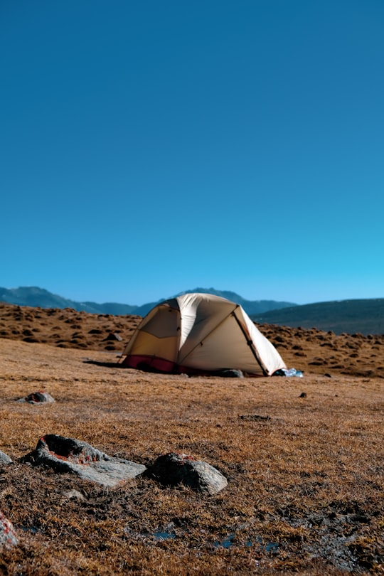white and gray tent on brown sand under blue sky during daytime in Xining China