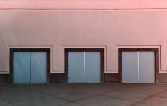 Close-up of the Romanian property's sturdy warehouse doors and surrounding paved area.