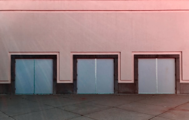 Close-up of the Romanian property's sturdy warehouse doors and surrounding paved area.