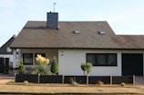 brown and white concrete house under blue sky during daytime