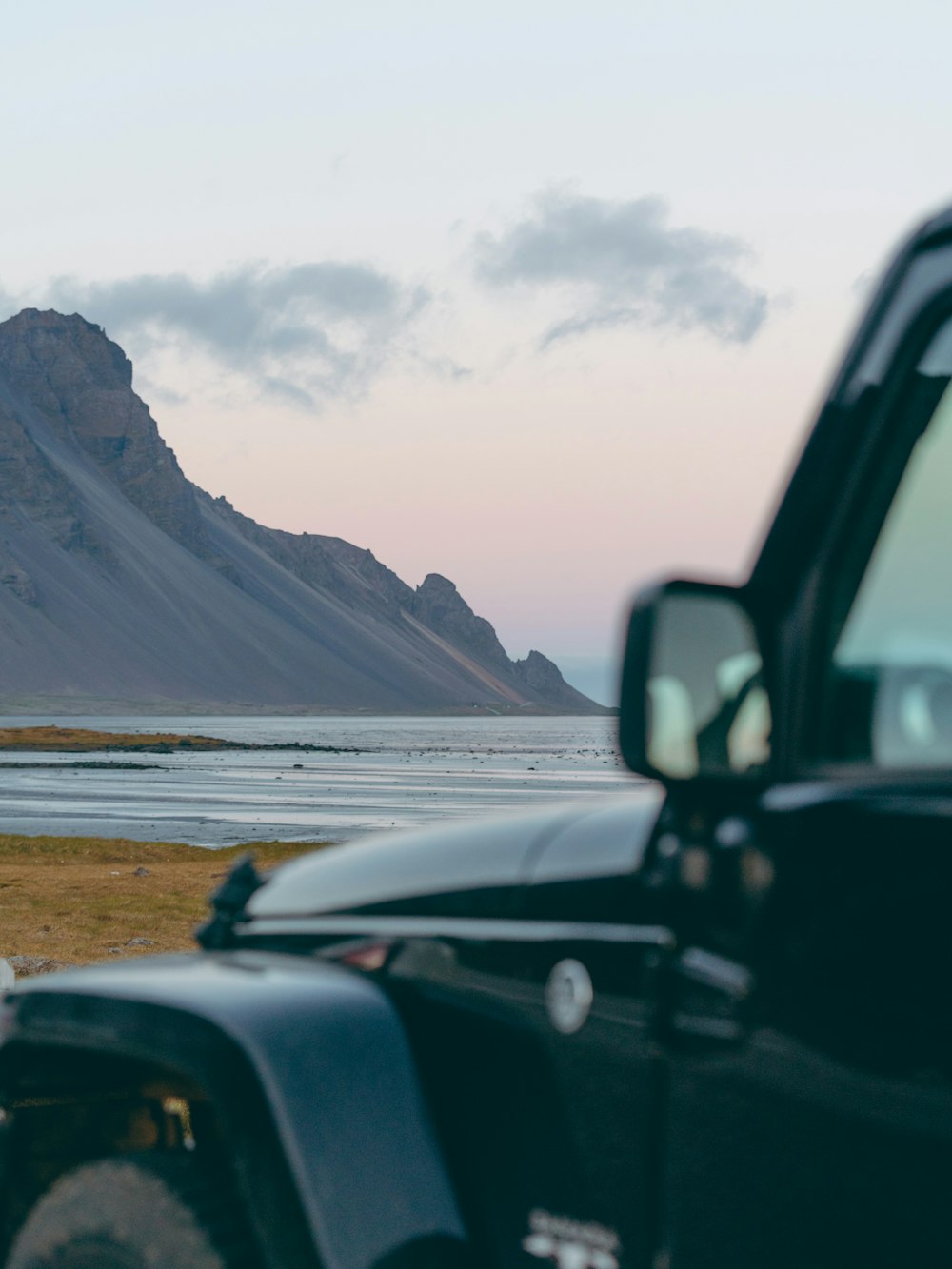 black car on road near snow covered mountain during daytime