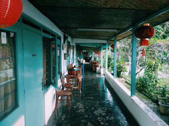 people sitting on brown wooden chairs during daytime in Bogor Indonesia