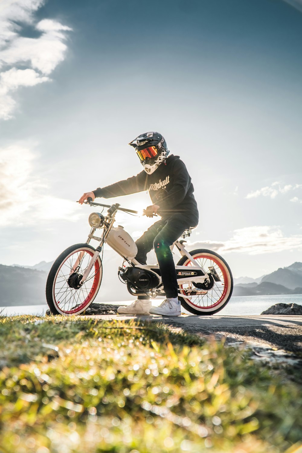 man in green jacket riding motocross dirt bike on mountain during daytime