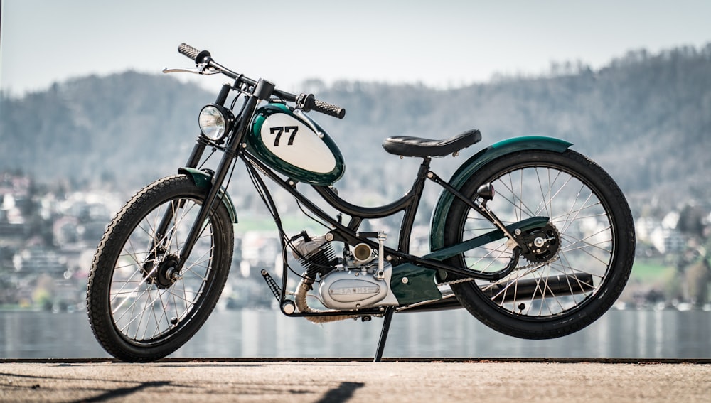 green and black motorcycle on brown sand during daytime