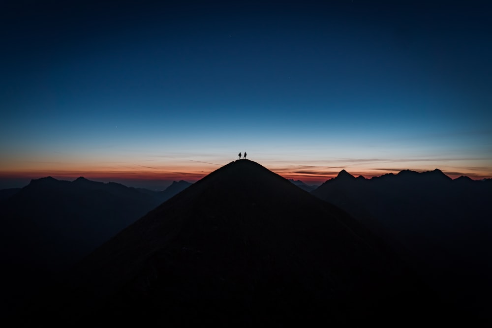 silhouette of mountain under blue sky during daytime