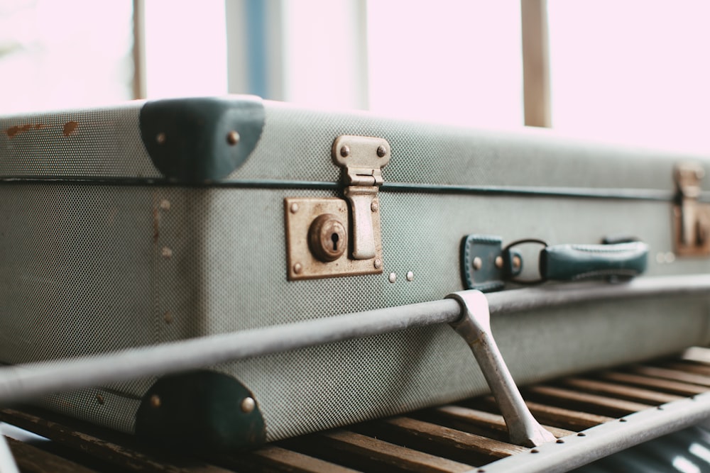 black suitcase on brown wooden table