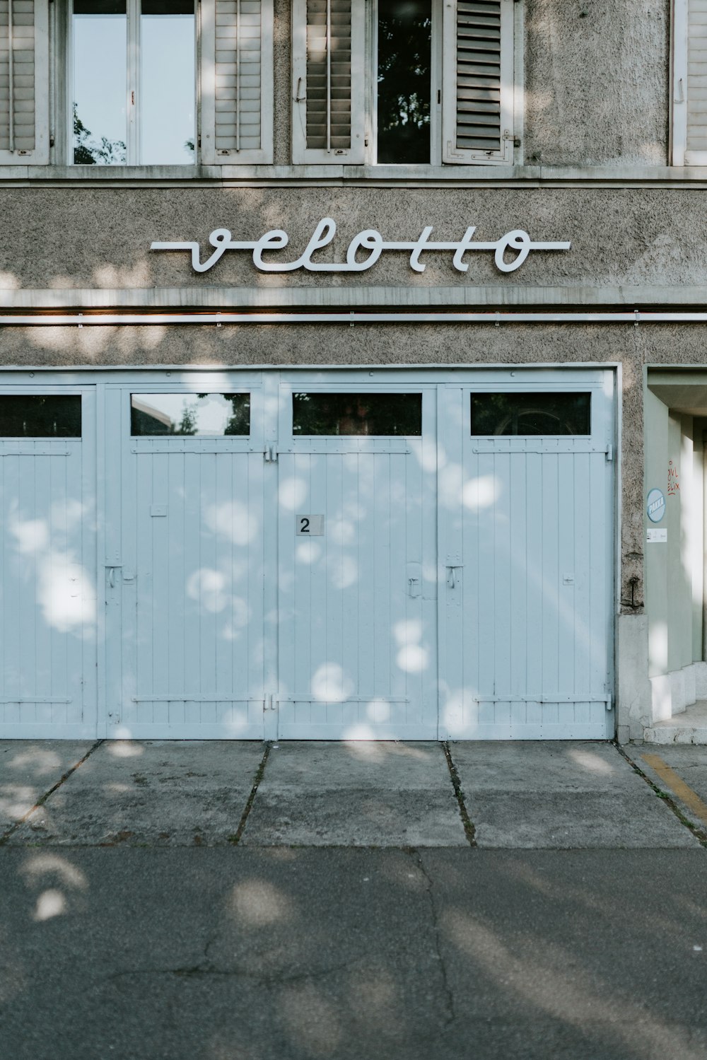 a couple of blue garage doors in front of a building