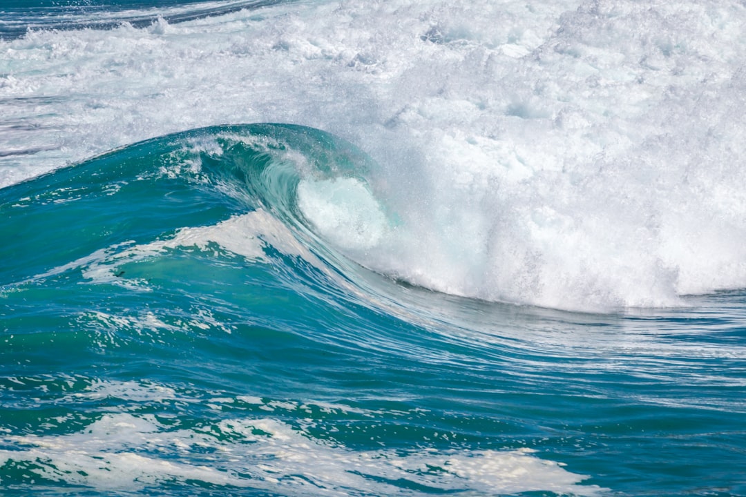 ocean waves crashing on shore during daytime