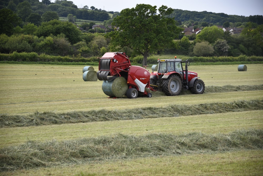 red tractor on green grass field during daytime