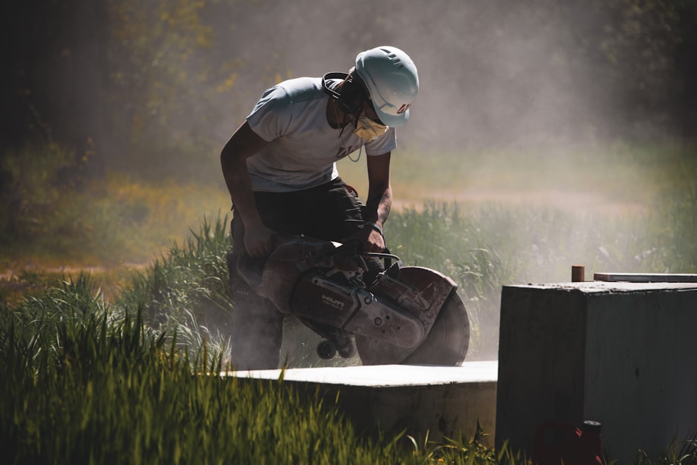 man in black t-shirt and black helmet sitting on concrete bench