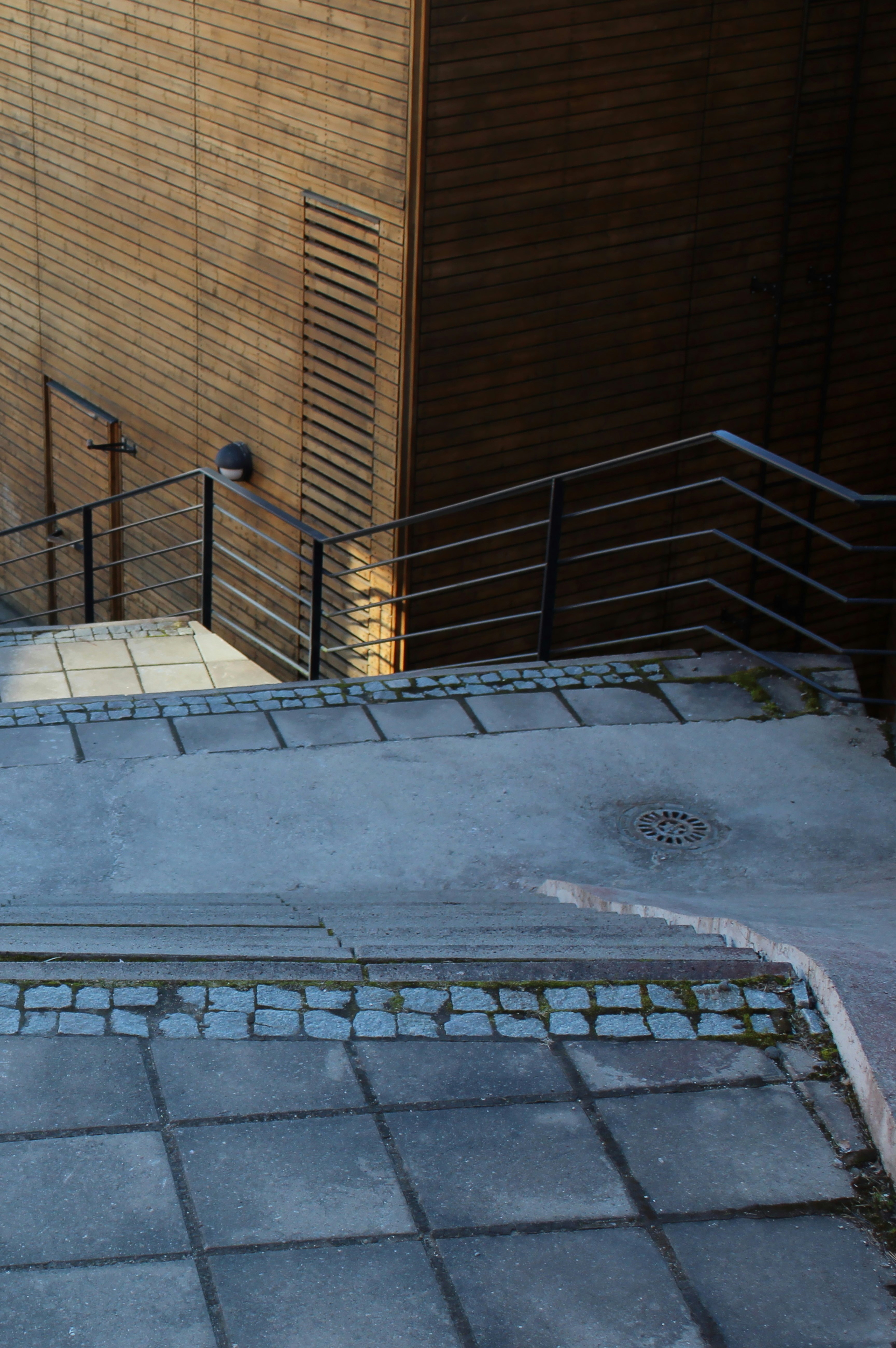 gray concrete staircase near brown concrete wall