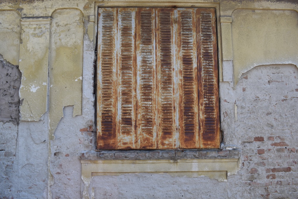 brown wooden window on white concrete wall