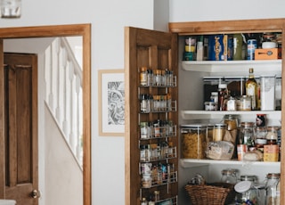 brown wooden shelf with bottles