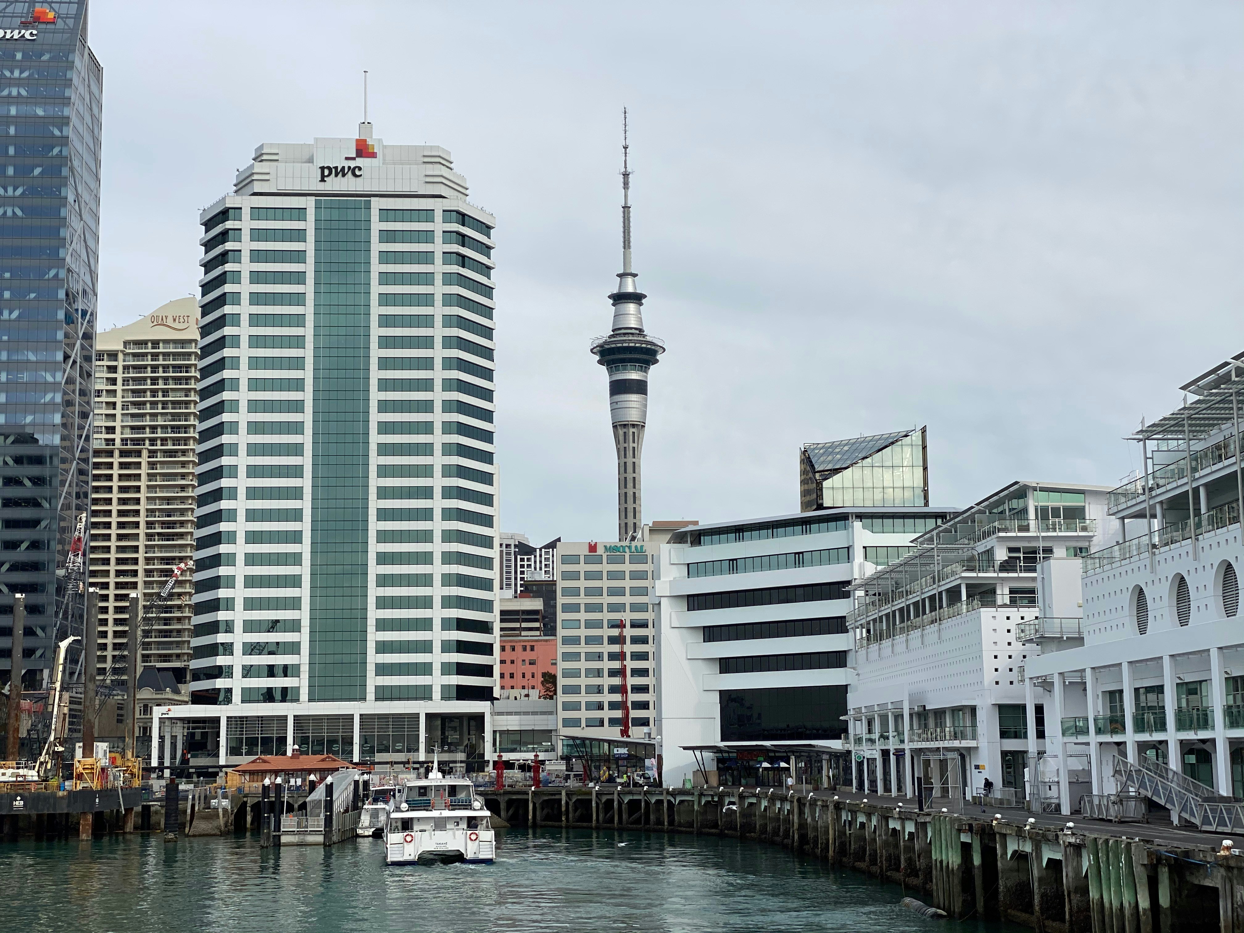 white and gray concrete building near body of water during daytime