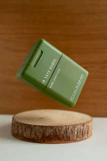 Sterilpro watermelon-scented hand sanitizer bottle placed next to fresh watermelon slices on a clean white surface