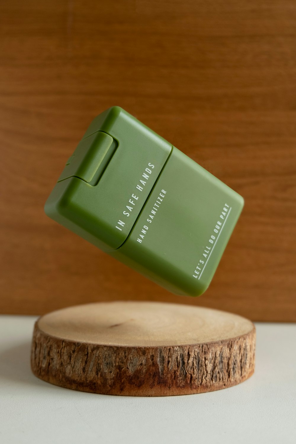 green plastic container on brown wooden round table