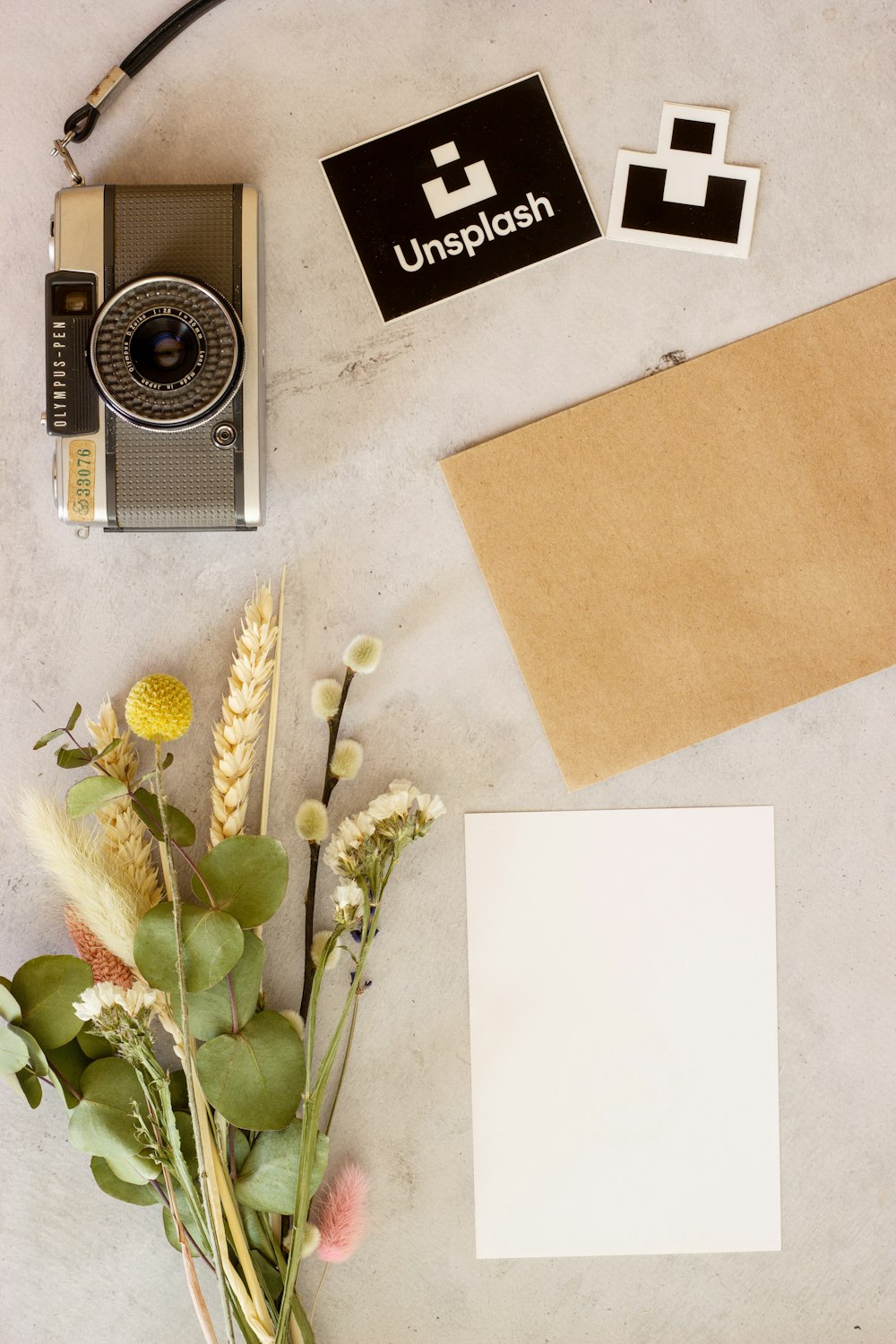 brown and black camera beside brown envelope