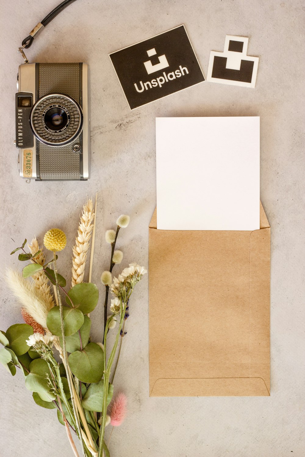 white and black camera beside white printer paper