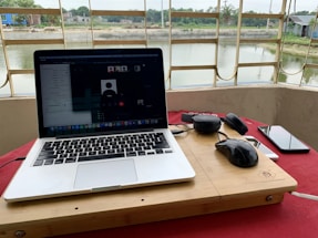 A serene online meeting setup with a laptop and notepad.