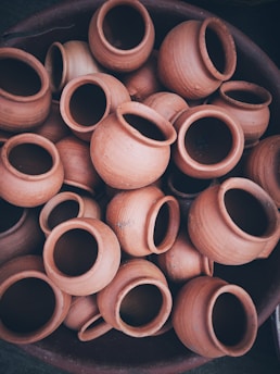 brown clay pot lot on black background