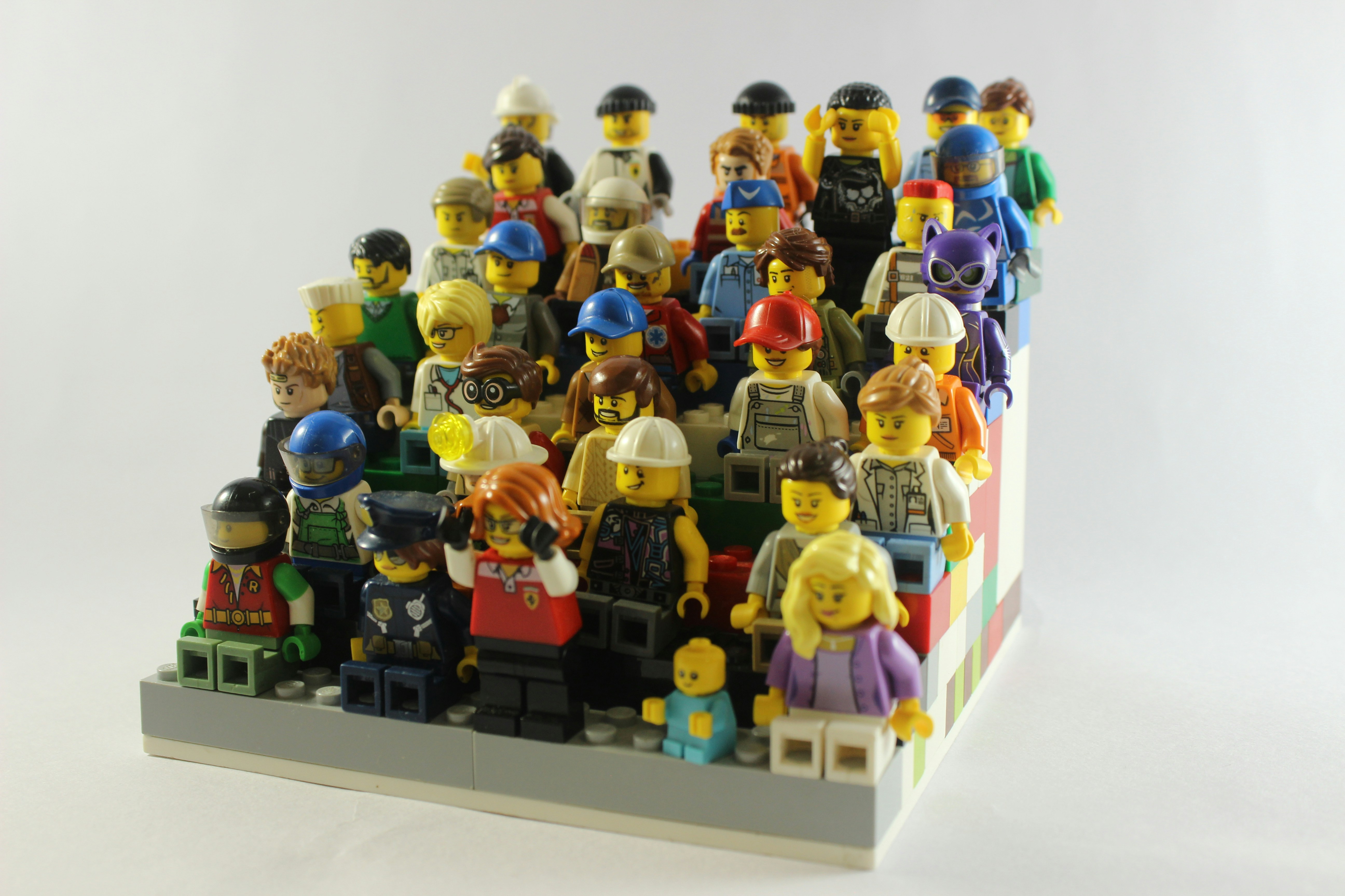 Close-up of a variety of LEGO minifigures lined up in playful poses.