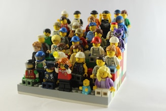A vibrant display of custom LEGO minifigures from Lord of the Rings and superhero themes arranged neatly on a clean white background.