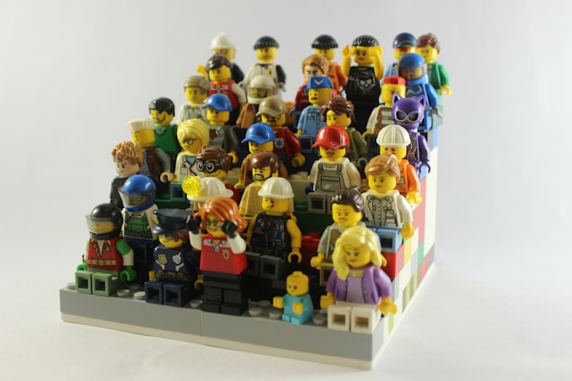 A vibrant display of custom LEGO minifigures from Lord of the Rings and superhero themes arranged neatly on a clean white background.